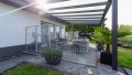 Stilvoller Outdoorbereich mit Glasüberdachung – ein Ort für gesellige Abende und ruhige Momente.